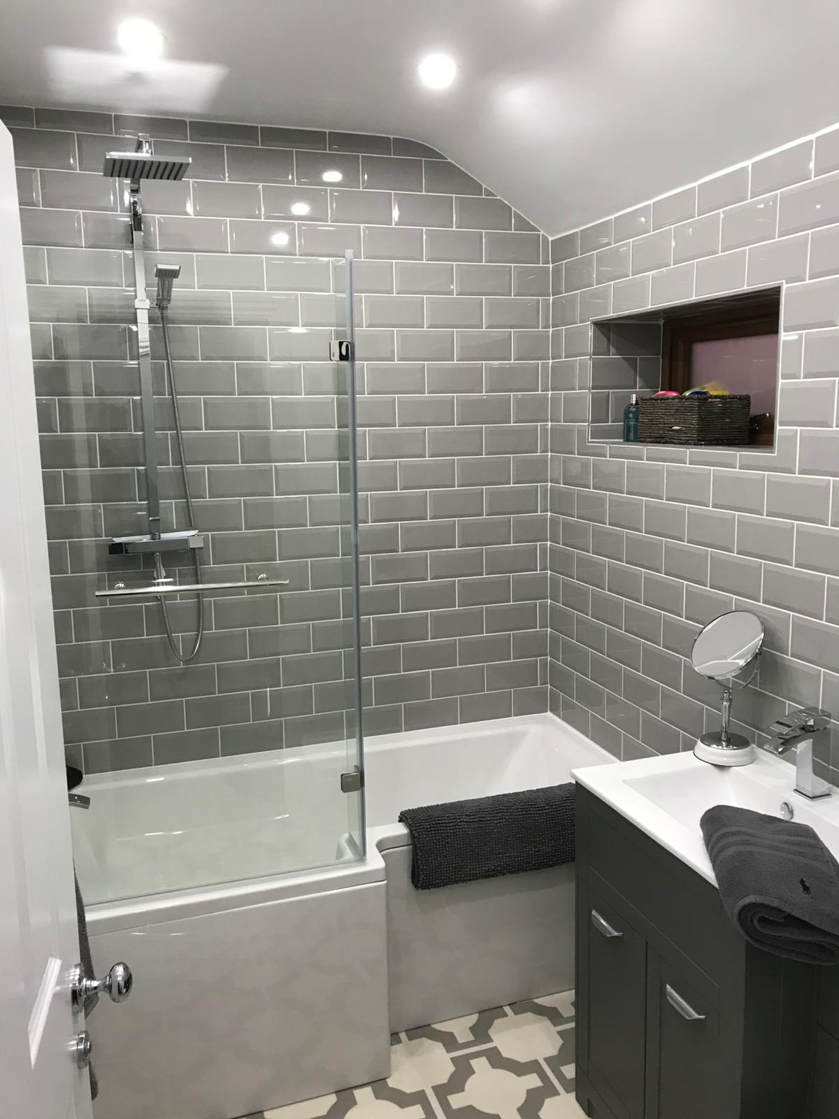 Modern bathroom with glass shower and dark vanity
