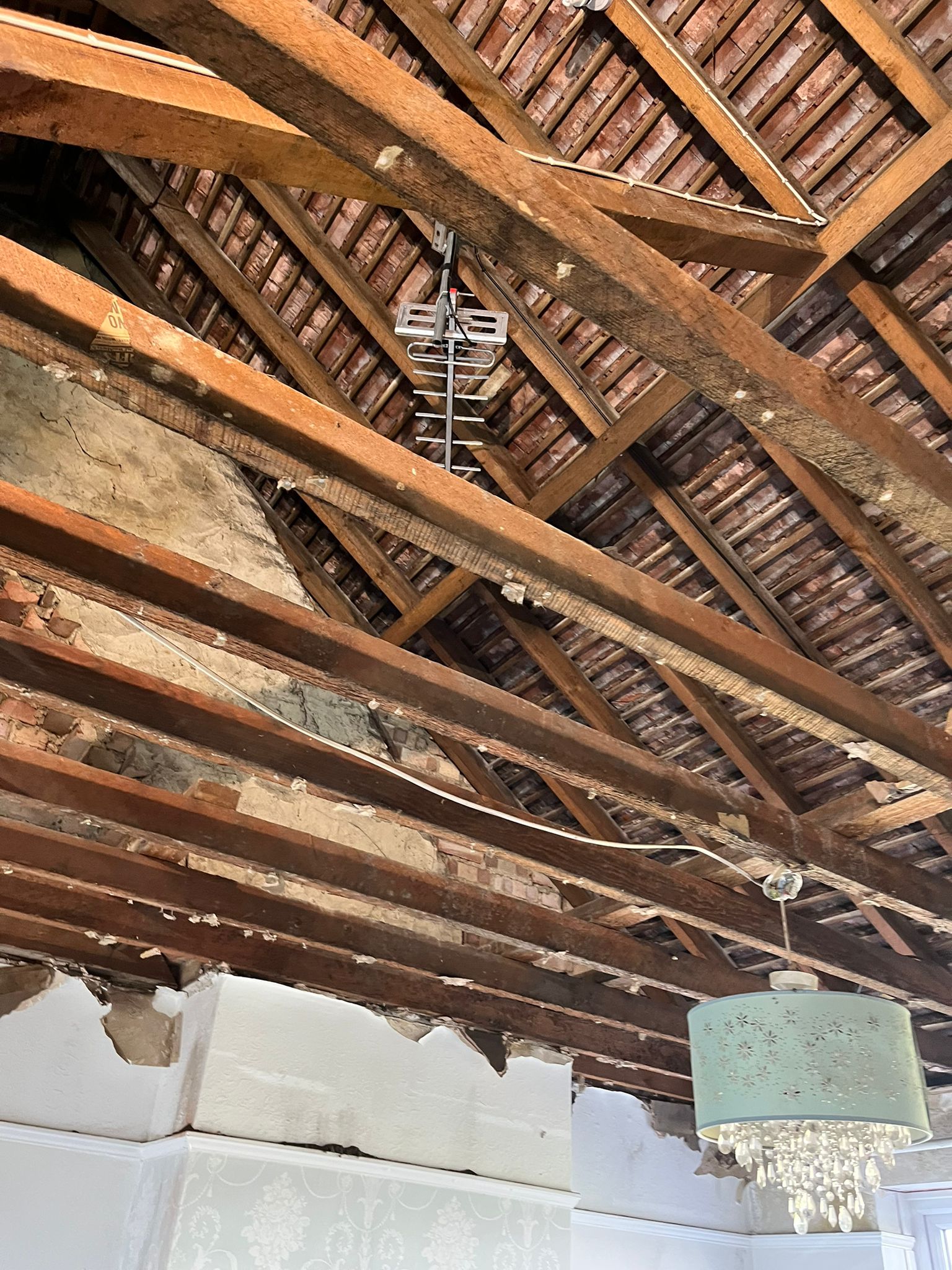 Before: damaged roof beams in poor condition