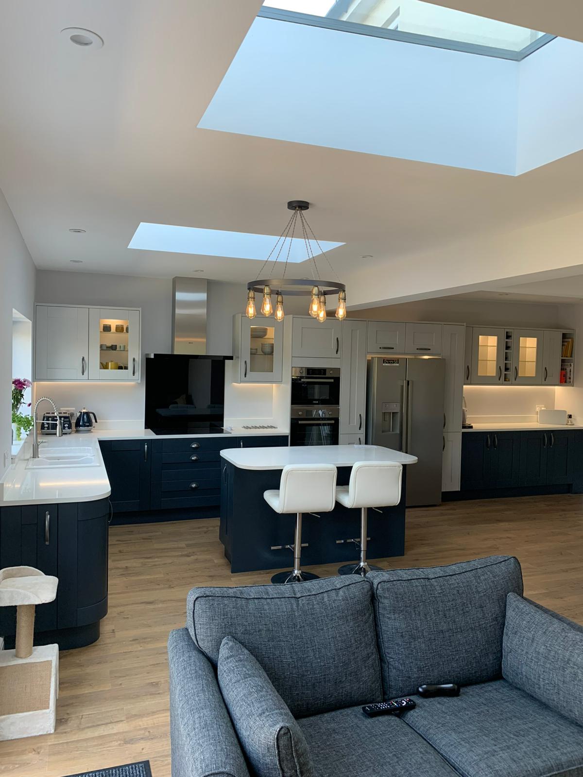 Modern open-plan kitchen and living space with skylights